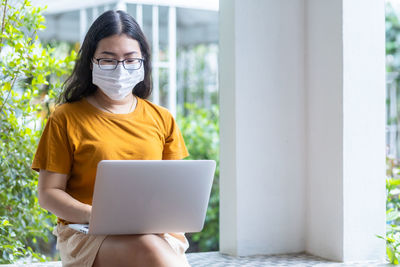 Midsection of woman using mobile phone