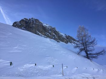 Scenic view of snow covered mountains against sky