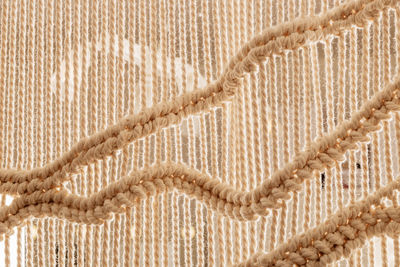 Homemade white macrame texture. home scandinavian boho decoration background