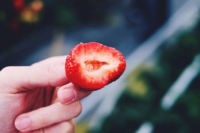 Close-up of hand holding strawberry