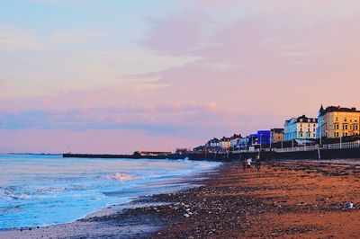Pier on sea at sunset