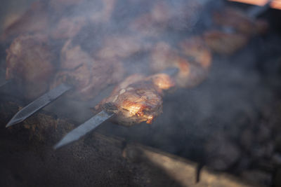 High angle view of fire on barbecue grill