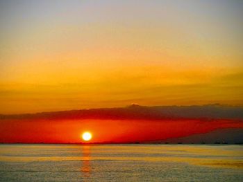 Scenic view of sea against romantic sky at sunset