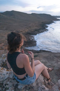 Woman sitting on rock