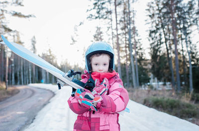 Portrait of a young girl holding cross country skis in sweden