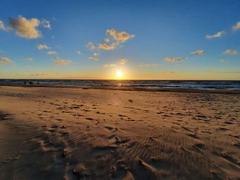 Scenic view of beach against sky during sunset