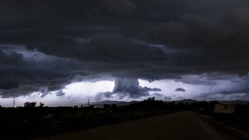 Panoramic view of storm clouds over road