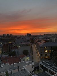 High angle view of illuminated buildings against sky during sunset