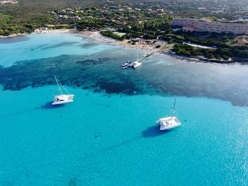 High angle view of sailboats sailing in sea