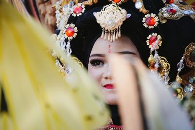 Smiling woman wearing headdress while looking away