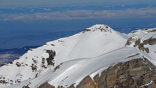 Scenic view of snow covered mountains against sky