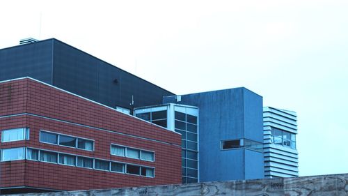 Low angle view of office building against clear sky