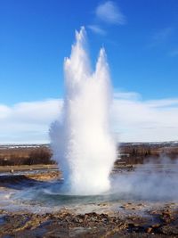 Panoramic view of waterfall against sky