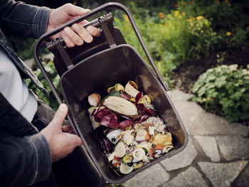 Man holding compost bucket, close up