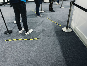 Low section of people standing on road