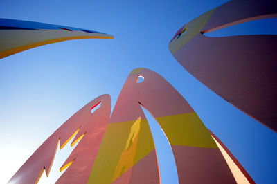 Low angle view of cropped built structure against blue sky