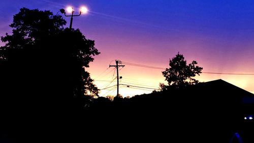 Low angle view of silhouette trees against sky during sunset