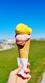 Cropped hand holding ice cream cone