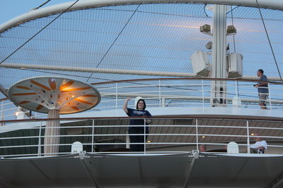 Low angle view of people on boat against sky