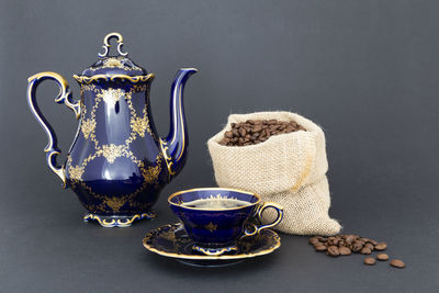 Close-up of coffee cup on table against black background