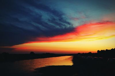 Scenic view of dramatic sky over sea during sunset