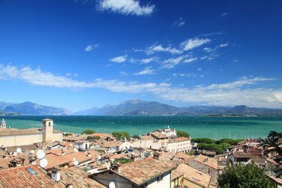High angle view of townscape by sea against sky