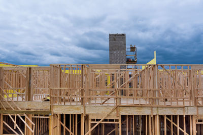 Construction site by building against sky