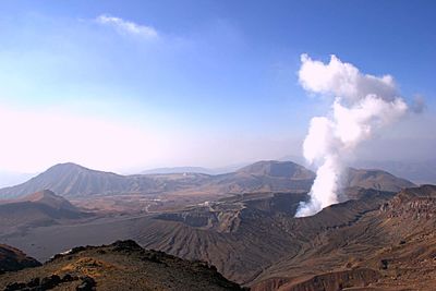 Smoke emitting from volcanic mountain against sky