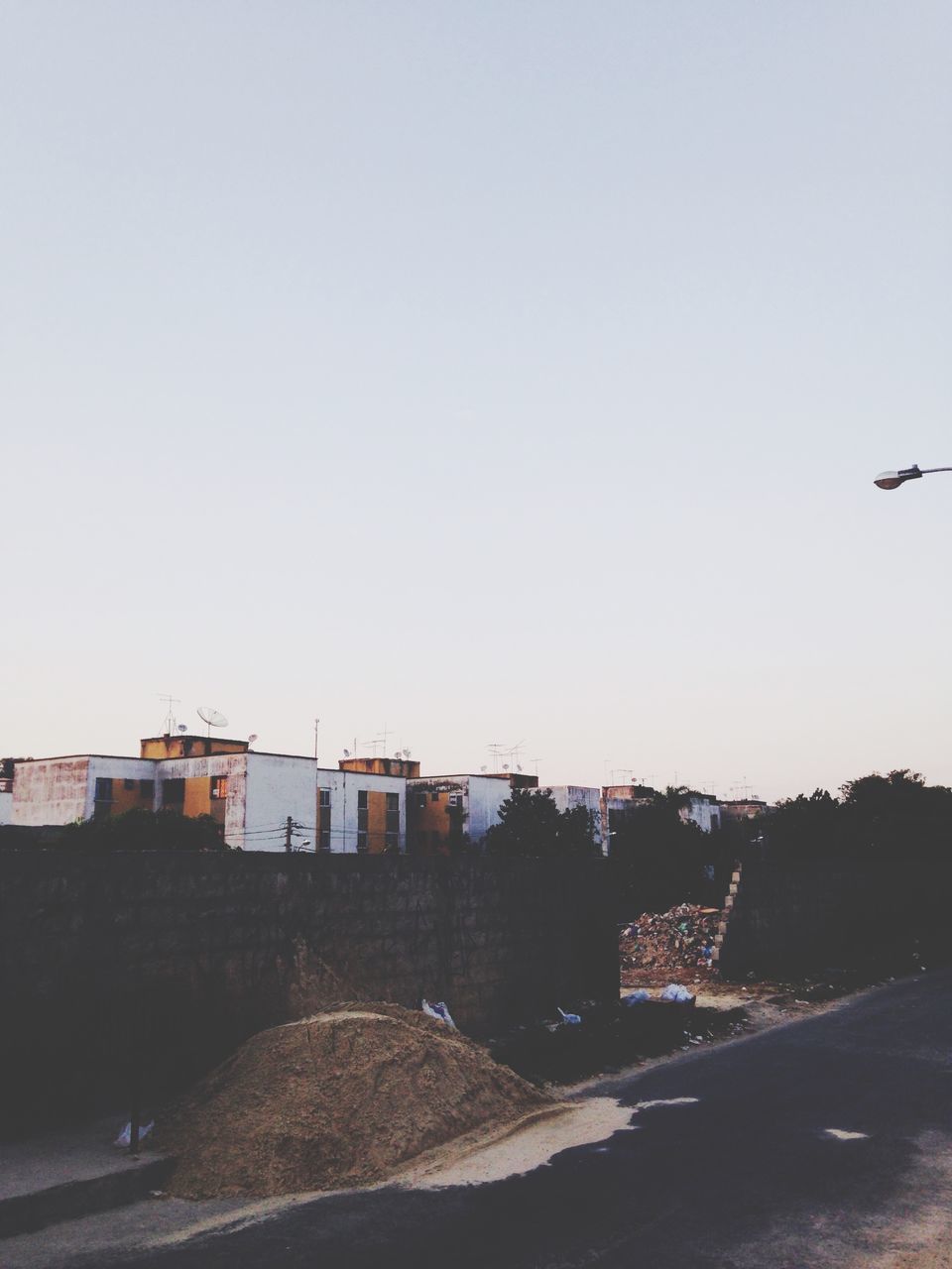 clear sky, copy space, built structure, architecture, building exterior, transportation, flying, bird, animal themes, road, outdoors, day, house, no people, sky, landscape, city, nature, street, mode of transport