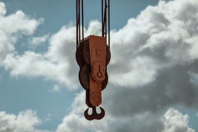 Low angle view of heart shape hanging against sky