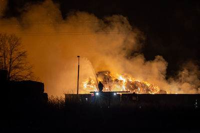 Panoramic view of fire at night