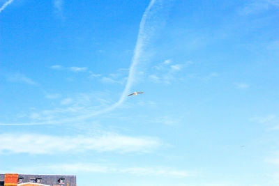 Low angle view of airplane flying against sky