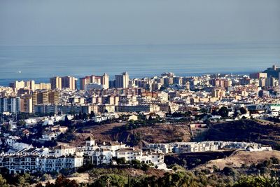 High angle view of buildings in city against sky