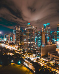 High angle view of illuminated buildings against sky at night