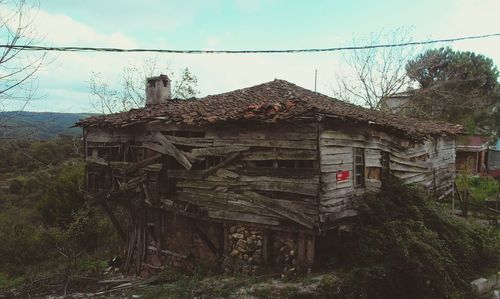 House by trees against clear sky