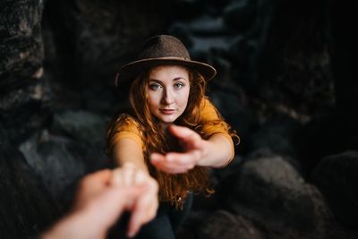 Portrait of young woman wearing hat