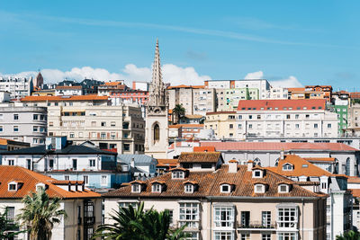 Buildings in city against sky