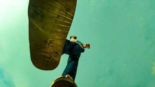 Low angle view of statue against blue sky