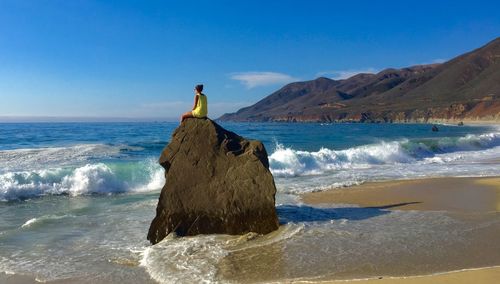 Man looking at sea against sky