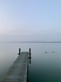 Pier over sea against sky