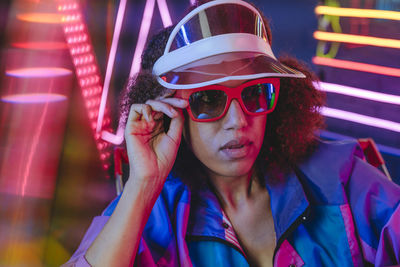 Portrait of young woman wearing sunglasses while standing outdoors