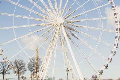 Low angle view of ferris wheel against sky