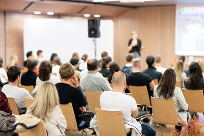 Rear view of people working in meeting