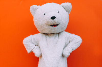 Close-up of stuffed toy against orange background