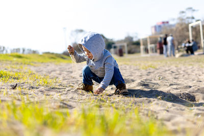 Toddler boy playing on the sand