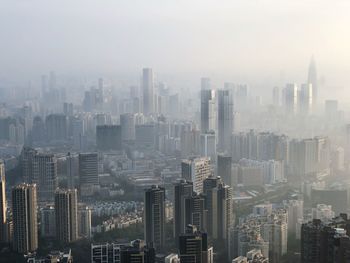 Aerial view of modern buildings in city against sky