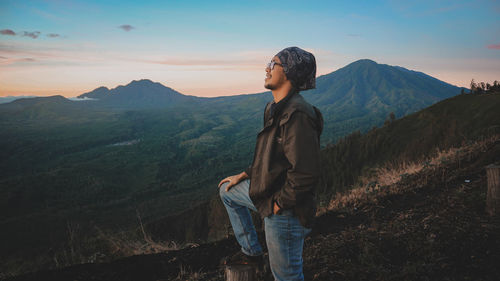 Full length of man standing on mountain against sky