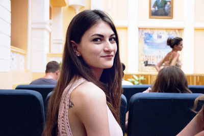 Portrait of young woman sitting outdoors