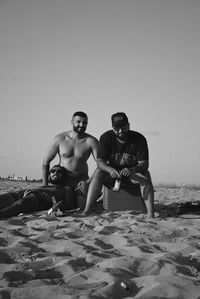 Full length of shirtless man standing against clear sky