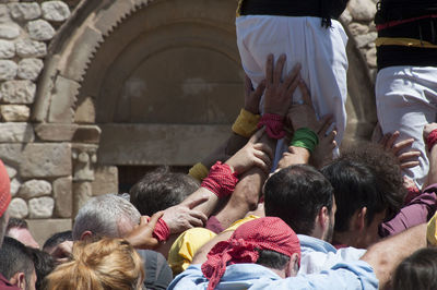 Rear view of people at temple against building